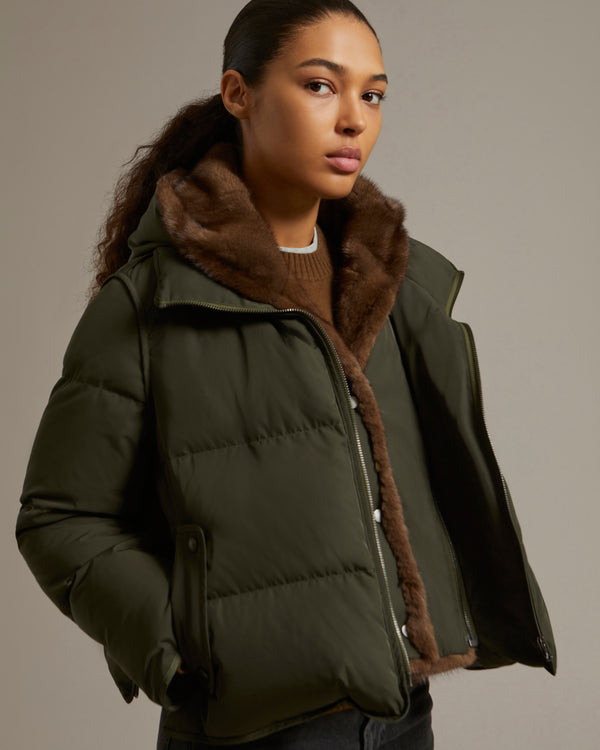 A line down jacket in technical fabric with long-haired mink hooded bib