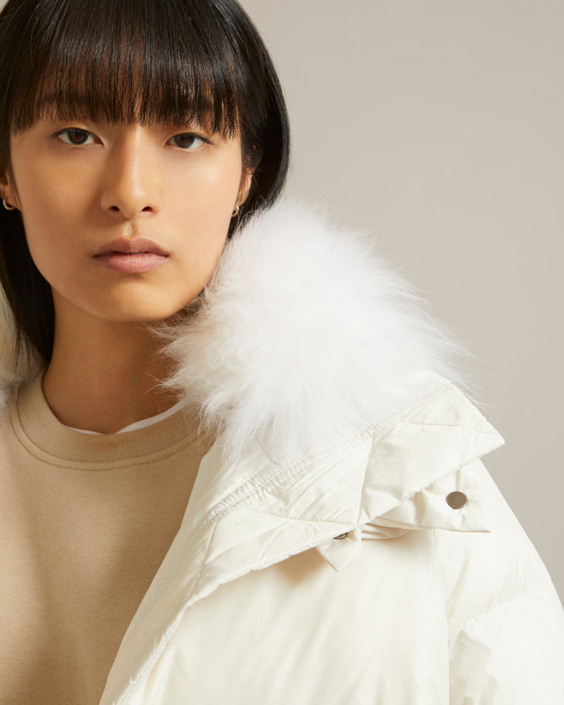 A line down jacket in water-repellent technical fabric with fluffy lambswool collar
