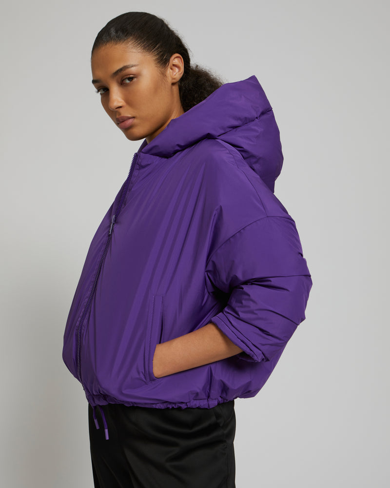 Reversible oversized down jacket in a smooth and quilted waterproof technical fabric