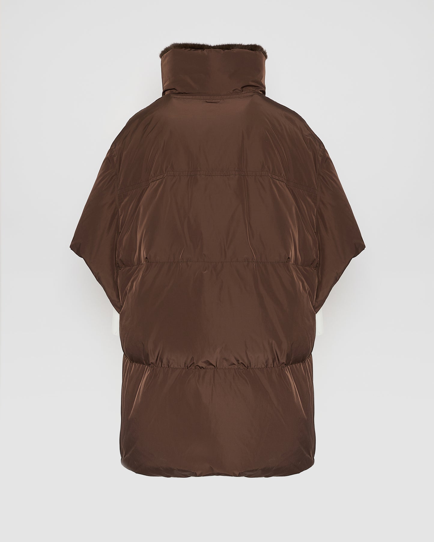 Technical fabric down cape with mink fur stand collar and lining.