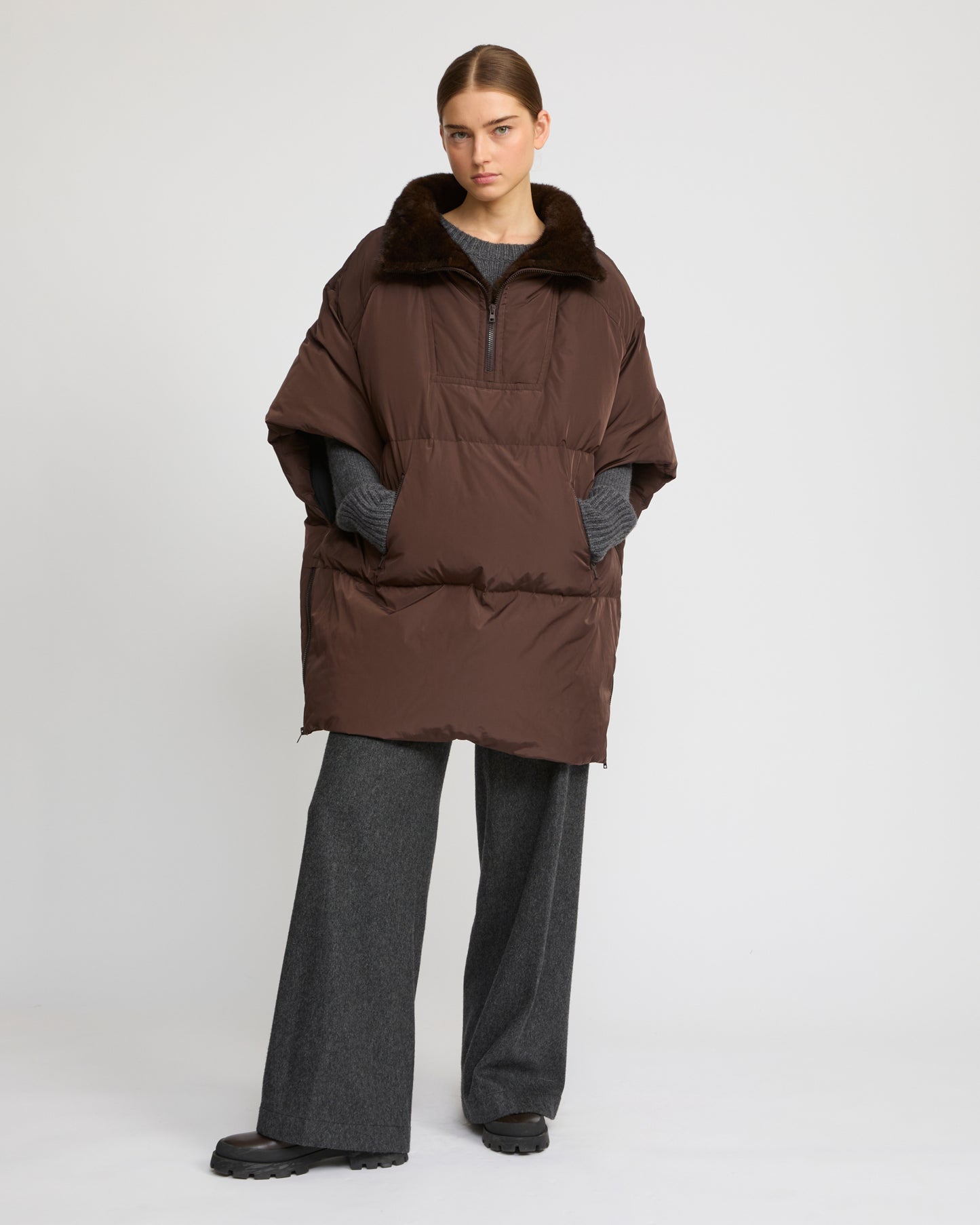 Technical fabric down cape with mink fur stand collar and lining.