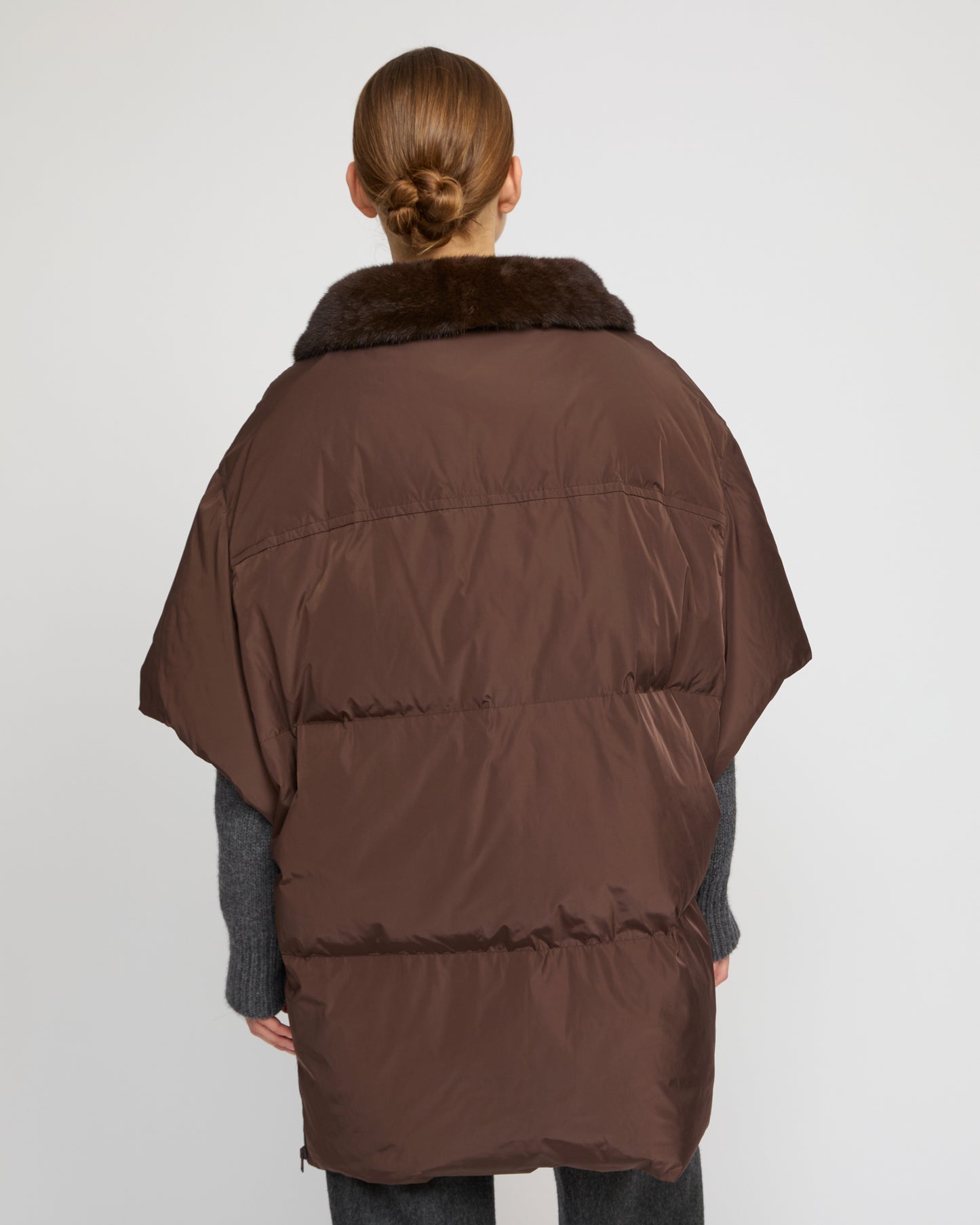 Technical fabric down cape with mink fur stand collar and lining.