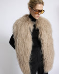 Merino knit gilet with curly long-haired lambskin